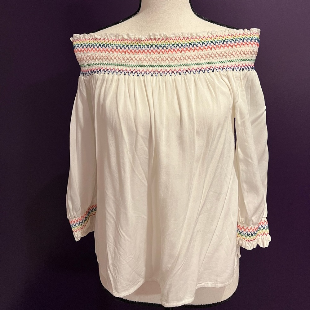 Off-the-shoulder white blouse with colorful detailing